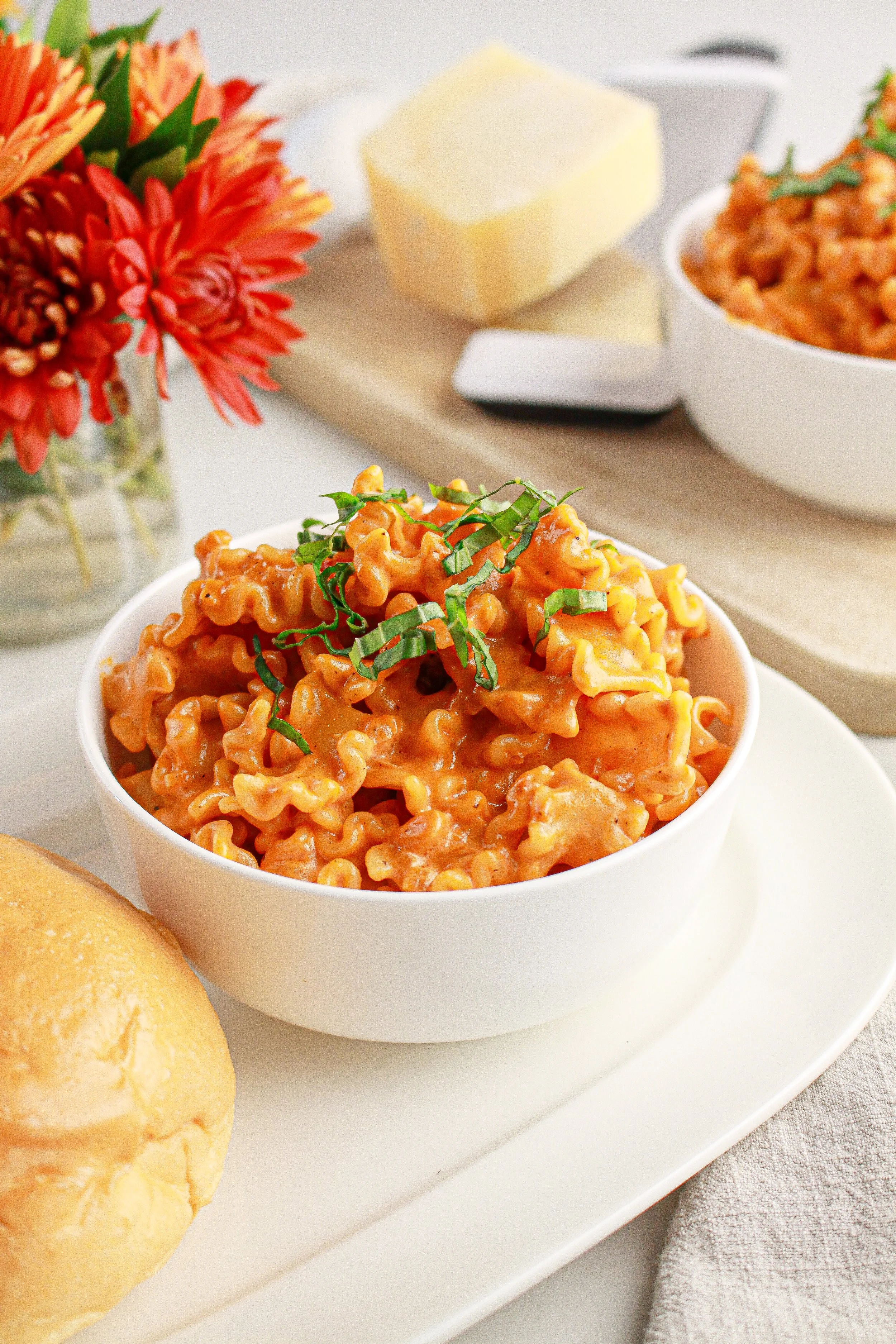 Bowl of pasta with tomato cream sauce and fresh basil